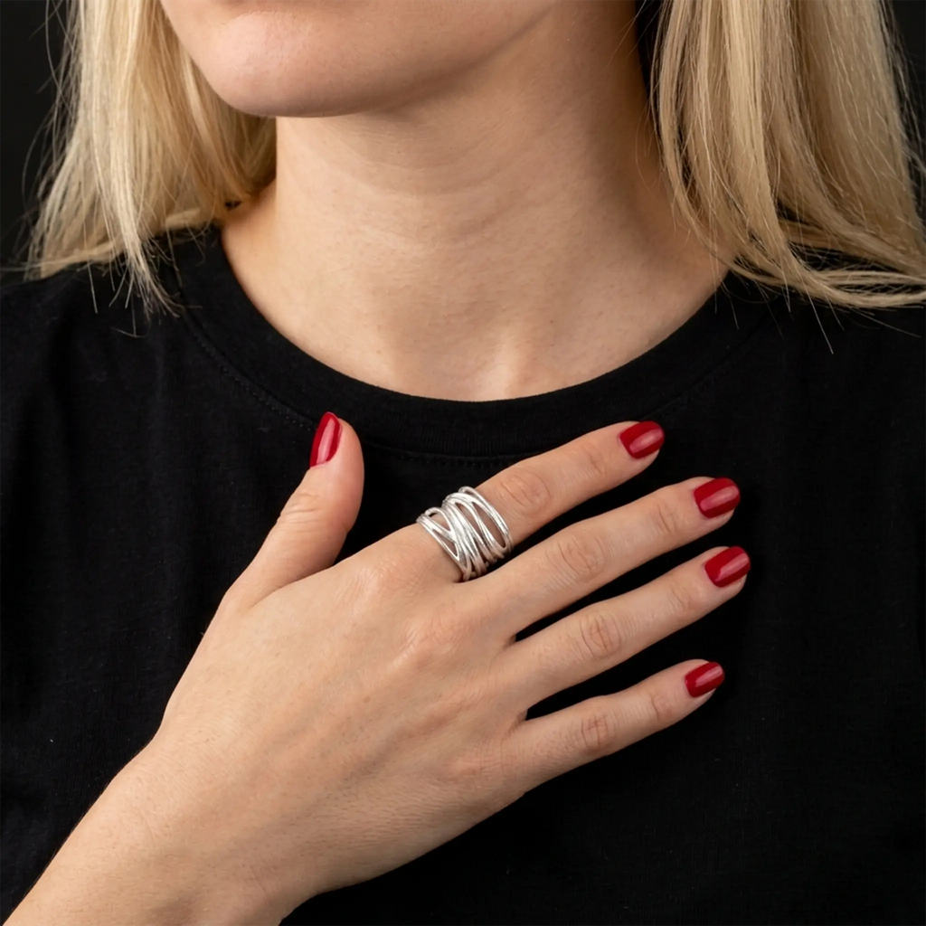 Hand mit rotem Nagellack auf schwarzem Shirt – 925 Silber Wickelring als offener Bandring, moderner Statement-Look