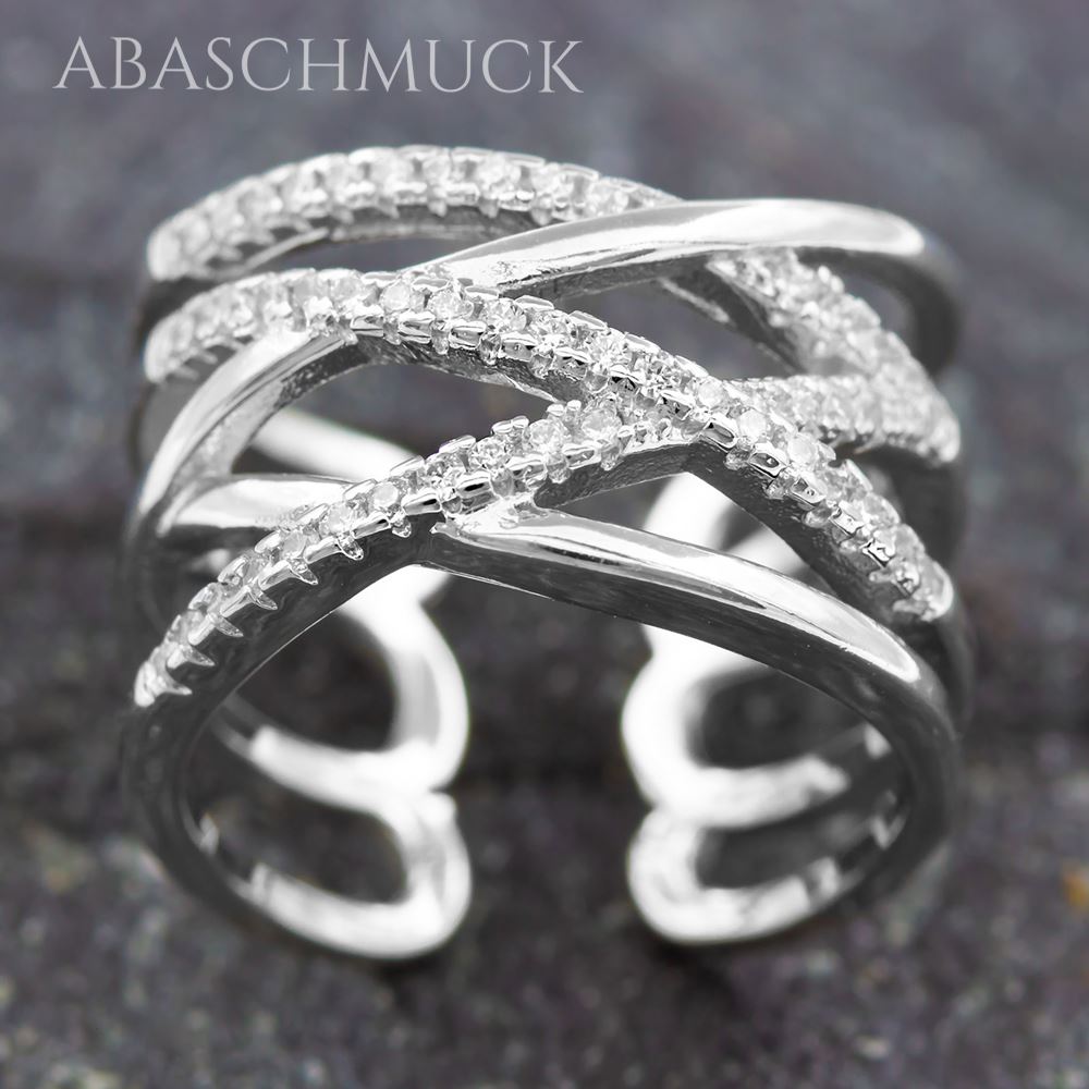 Filigraner überkreuzter Silberring 925 auf dunklem Steinuntergrund.